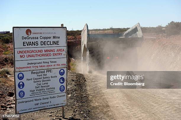 Dust billows behind a truck heading into the box cut mine at the Sandfire Resources NL copper operations at DeGrussa, 559 miles north of Perth,...