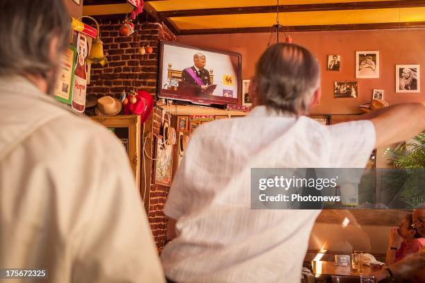 Citizens of Brussels watch in a pub during the Oath taking of King Philippe.