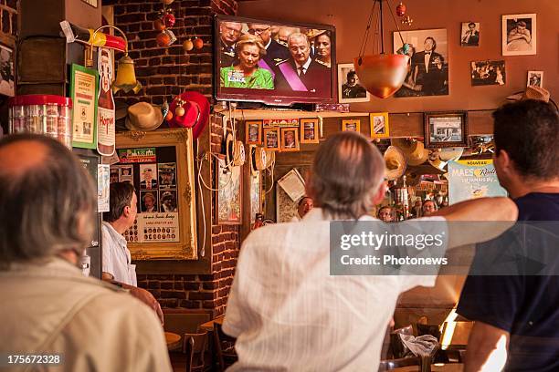 Citizens of Brussels watch in a pub during the Oath taking of King Philippe.