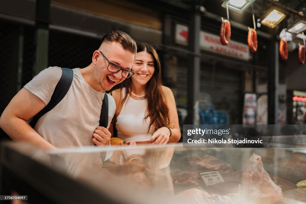 Couple choosing a meat piece