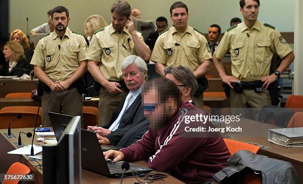 Andre E and his laywers wait for the start of day 39 of the NSU neo-Nazi murders trial at the Oberlandesgericht Muenchen courthouse on August 6, 2013...
