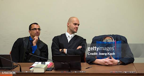 Holger G. And his laywers wait for the start of day 39 of the NSU neo-Nazi murders trial at the Oberlandesgericht Muenchen courthouse on August 6,...
