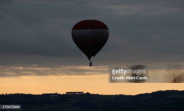 Hot air balloon flies over Bristol during a dawn flight on August 6, 2013 in Bristol, England. The early morning flight of over twenty balloons over...