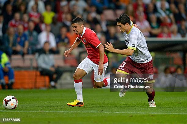 Zakaria Bakkali of PSV compete for the ball with Steve Colpaert of Zulte-Waregem during the UEFA Champions League Third qualifying round match, first...