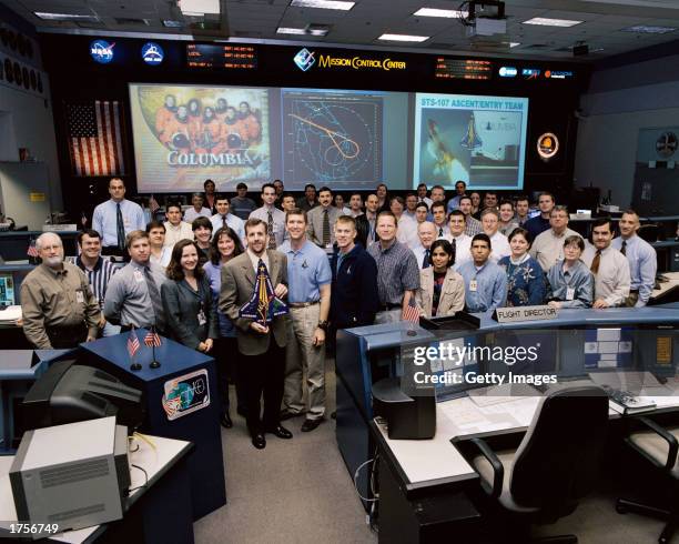 Members of the STS-107 Ascent/Entry team pose for a group portrait in the shuttle flight control room in Houston Mission Control Center January 2003...