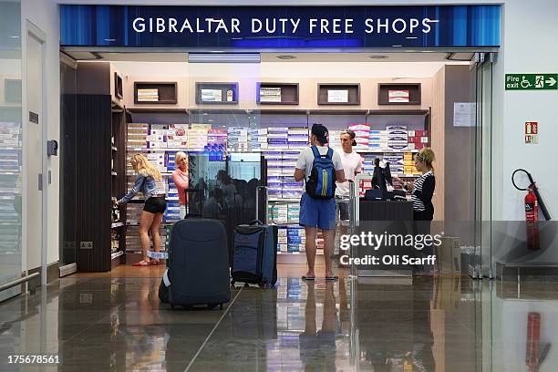 Passengers peruse a duty-free shop in the terminal building of Gibraltar International Airport on August 6, 2013 in Gibraltar. Tensions between the...