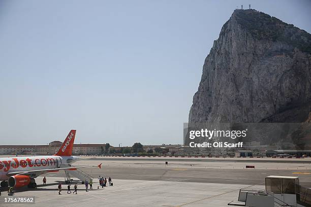 Passengers board a flight at Gibraltar International Airport on August 6, 2013 in Gibraltar. Tensions between the British and Spanish governments...