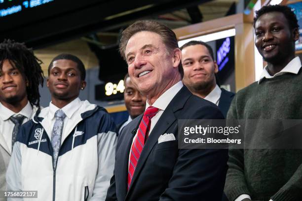 Rick Pitino, head coach of the St. John's Red Storm basketball team, center, at the New York Stock Exchange in New York, US, on Tuesday, Oct. 31,...