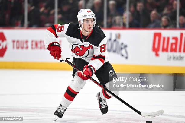 Jack Hughes of the New Jersey Devils skates the puck during the first period against the Montreal Canadiens at the Bell Centre on October 24, 2023 in...