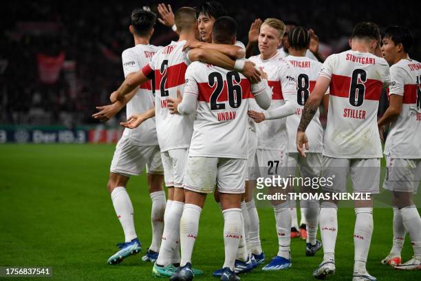 Stuttgart's German forward Deniz Undav celebrates scoring the opening goal with his teammates during the German Cup second round football match VfB...
