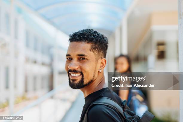 smiling college student on campus - latin music stock pictures, royalty-free photos & images