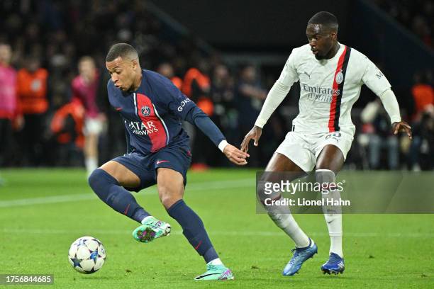 Kylian Mbappé of Paris Saint-Germain and Pierre Kalulu of AC Milan during the UEFA Champions League match between Paris Saint-Germain and AC Milan at...