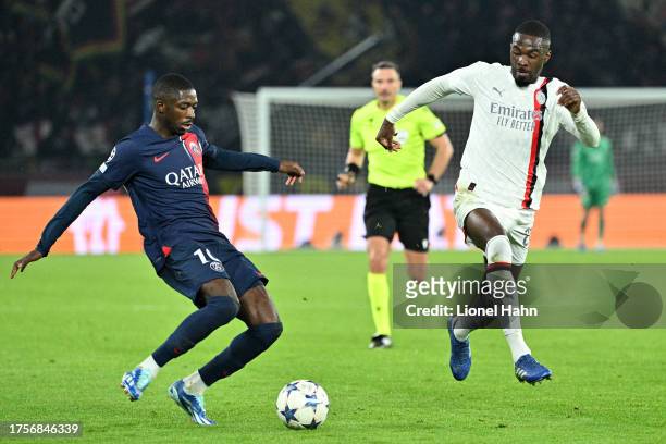 Ousmane Dembélé of PSG and Pierre Kalulu of AC Milan during the UEFA Champions League match between Paris Saint-Germain and AC Milan at Parc des...