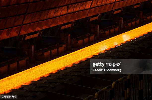 Super heated steel bar moves along the production line in the hot strip shop at the ArcelorMittal Poland SA steel mill in Krakow, Poland, on Tuesday,...