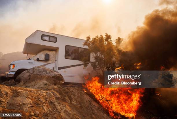 Flames beside an RV during the Highland Fire in Aguanga, California, US, on Tuesday, Oct. 31, 2023. A wildfire fueled by gusty Santa Ana winds ripped...