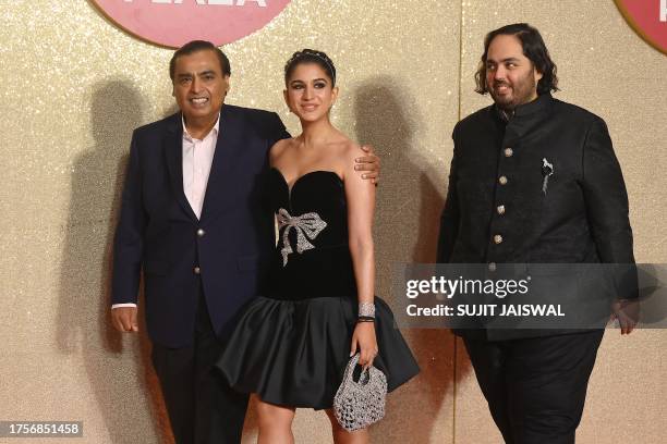 Chairman and Managing Director of Reliance Industries, Indian billionaire businessman Mukesh Ambani poses with Radhika Merchant and his son Anant...
