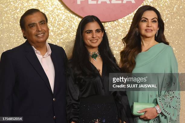 Chairman and Managing Director of Reliance Industries, Indian billionaire businessman Mukesh Ambani poses with his wife and Founder Chairperson of...