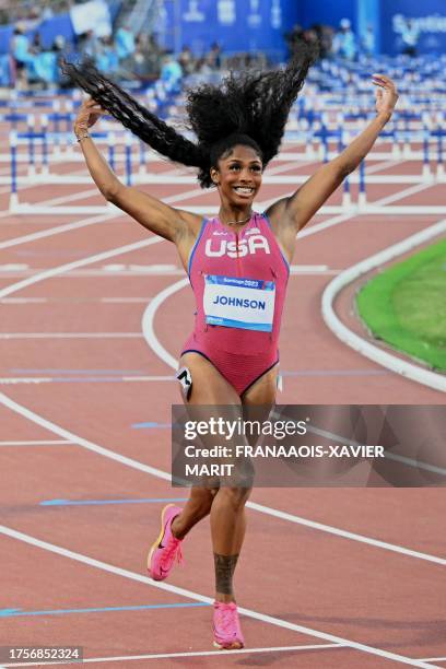 S Alaysha Alexzandria Johnson celebrates after winning the women's 100m hurdles semifinal heat 1 of the Pan American Games Santiago 2023 at the...