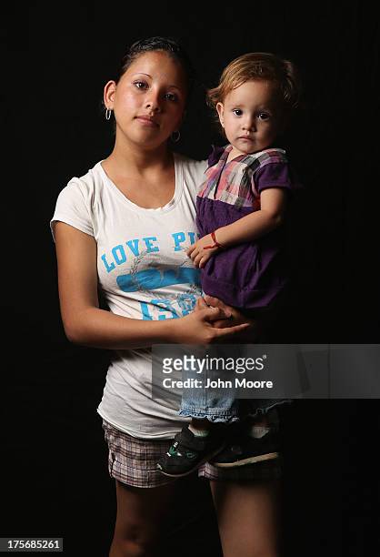 Salvadorian immigrant Stefanie Elizabeth holds her daughter Emily Nicole, 18 months, while spending another night at the Hermanos en el Camino...