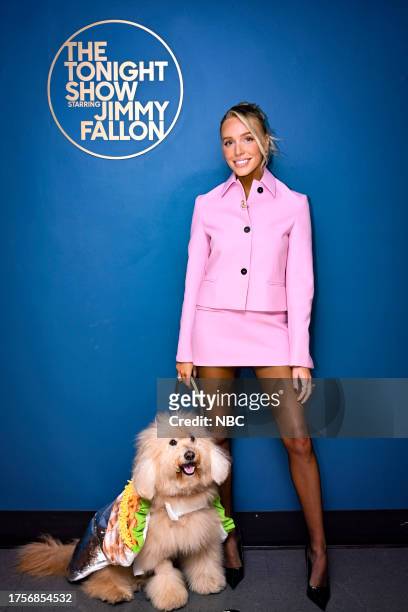 Episode 1865 -- Pictured: Podcaster Alex Cooper poses backstage with her dog Henry on Tuesday, October 31, 2023 --