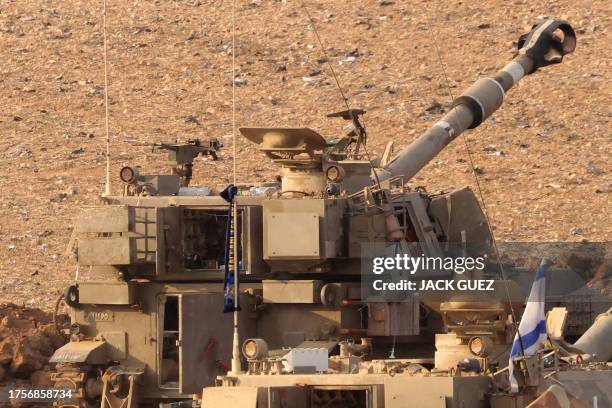 Scarf showing flag of Israeli football club Maccabi Tel Aviv FC is tied to the antenna of an Israeli army artillery howitzer stationed at a position...