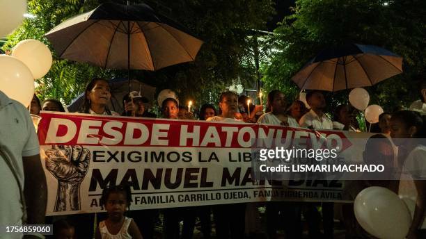People march during a demonstration for Liverpool's Colombian football player Luis Diaz's father after he was kidnapped, in Barrancas, La Guajira,...