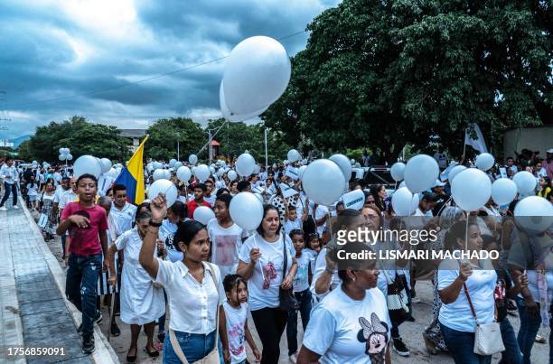 People march during a demonstration for Liverpool's Colombian football player Luis Diaz's father after he was kidnapped, in Barrancas, La Guajira,...
