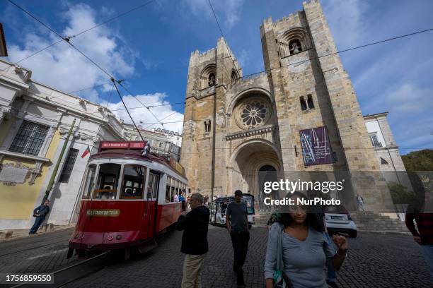 Tram is seen running near Lisbon's cathedral in the Alfama district. Lisbon, October 30, 2023. Graca and Alfama are two districts in Lisbon,...