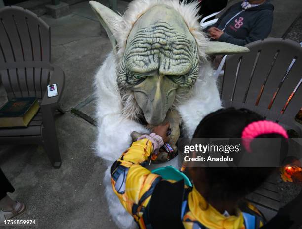 Parade participants in costume attend the 2023 Halloween parade as kids pick up candies in Sausalito, California, United States on October 31, 2023.