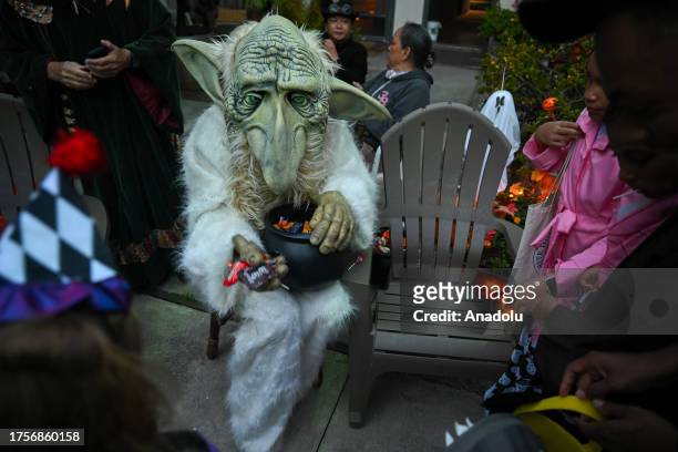 Parade participants in costume attend the 2023 Halloween parade as kids pick up candies in Sausalito, California, United States on October 31, 2023.