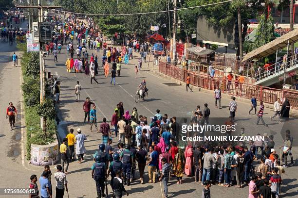 Garment workers block roads as they take part in a protest in Dhaka on November 1, 2023. Thousands of Bangladeshi garment workers barricaded roads in...