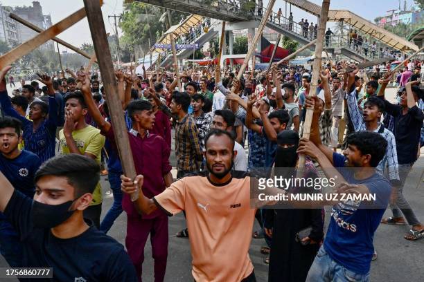 Garment workers block roads as they take part in a protest in Dhaka on November 1, 2023. Thousands of Bangladeshi garment workers barricaded roads in...