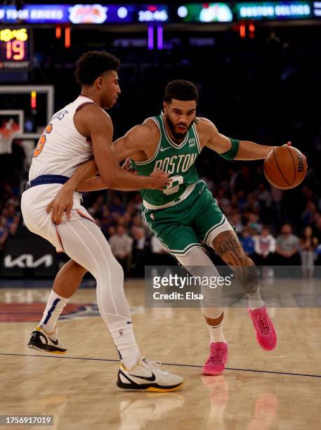 Jayson Tatum of the Boston Celtics tries to get past Quentin Grimes of the New York Knicks in the first half at Madison Square Garden on October 25,...