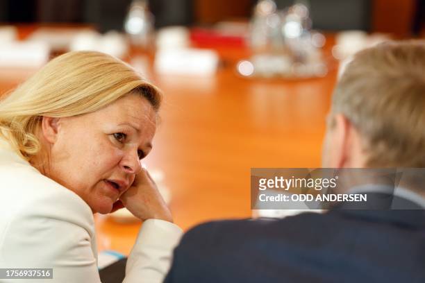 German Interior Minister Nancy Faeser speaks with German Finance Minister Christian Lindner prior to the weekly cabinet meeting at the Chancellery in...