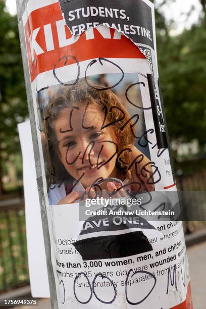 Posters distributed around the New York University campus of people kidnapped by Hamas on the October 7 raid of Israel are vandalized and covered...