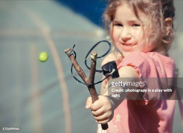 girl play with sling - slingshot stock pictures, royalty-free photos & images