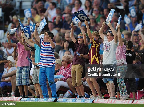 Children wave '6' cards during the Friends Life T20 Quarter Final between Northamptonshire Steelbacks and Durham Dynamosat The County Ground on...