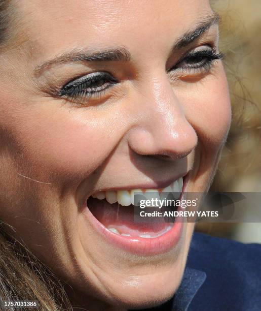 Kate Middleton laughs after a visit to Witton Country Park with her fiancee Britain's Prince William in Darwen, Lancashire, north-west England, on...