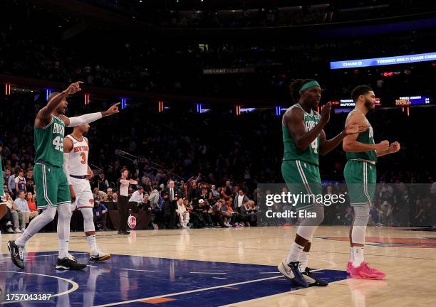 Al Horford,Jrue Holiday and Jayson Tatum of the Boston Celtics celebrate the win over the New York Knicks at Madison Square Garden on October 25,...