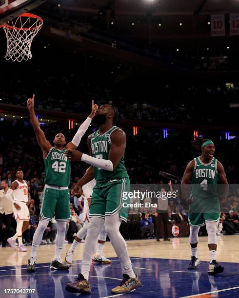Al Horford,Jrue Holiday and Jaylen Brown of the Boston Celtics celebrate the win over the New York Knicks at Madison Square Garden on October 25,...