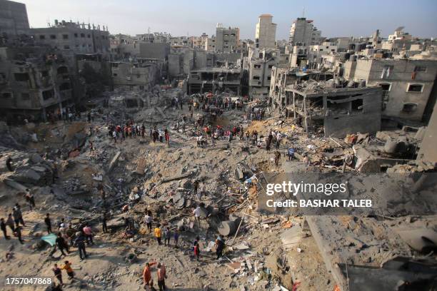 Palestinians check the destruction in the aftermath of an Israeli strike the previous night in the Jabalia camp for Palestinian refugees in the Gaza...