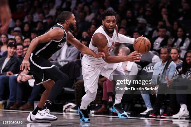 Donovan Mitchell of the Cleveland Cavaliers is guarded by Mikal Bridges of the Brooklyn Nets during the fourth quarter at Barclays Center on October...