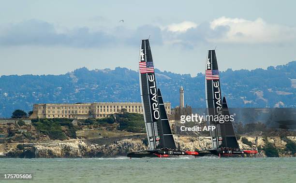 Oracle Team USA sails its AC72 catamarans past Alcatraz Island while training for September's America's Cup on August 6 in San Francisco. AFP...