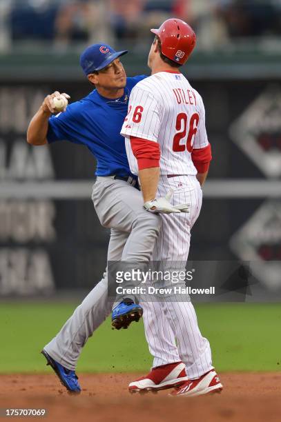 Chase Utley of the Philadelphia Phillies breaks up a double play attempt by Darwin Barney of the Chicago Cubs in the first inning at Citizens Bank...