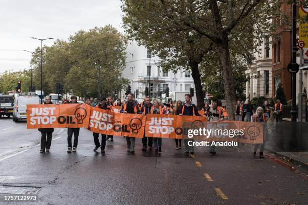 Environmental activists from Just Stop Oil slow march blocking traffic near Earl's Court as they continue their latest round of protest actions...