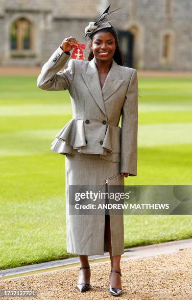 British-Nigerian football executive Eniola Aluko poses with their medal after being appointed an Officer of the Order of the British Empire following...