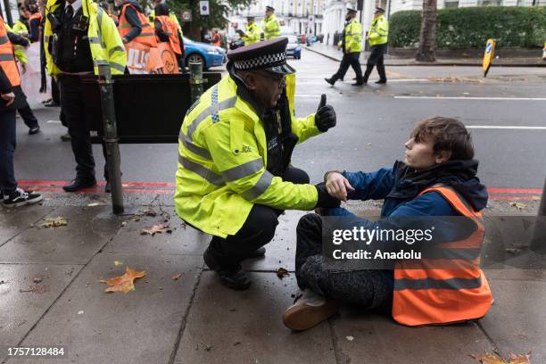 Police officers arrest environmental activists from Just Stop Oil near Earl's Court as they continue their slow marches during latest round of...