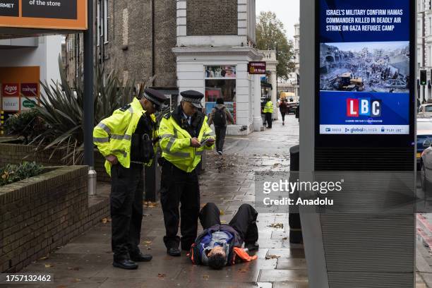 Police officers arrest environmental activists from Just Stop Oil near Earl's Court as they continue their slow marches during latest round of...
