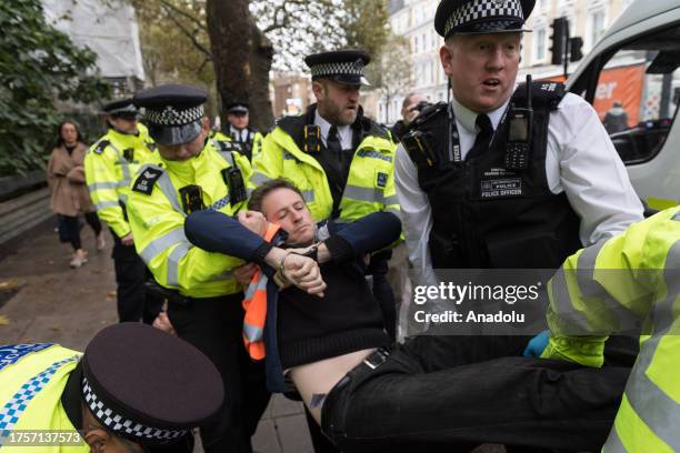 Police officers arrest environmental activists from Just Stop Oil near Earl's Court as they continue their slow marches during latest round of...