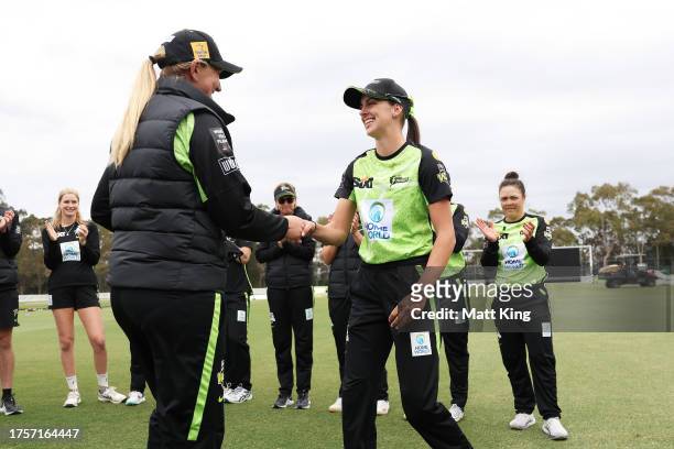 Ebony Hoskin of the Thunder receives her Thunder debut cap from Sammy-Jo Johnson of the Thunder during the WBBL match between Sydney Thunder and...